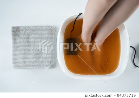 procedure of ionic detox foot bath machine in spa beauty center isolated procedure of ionic detox foot bath machine in spa beauty center isolated 94373719