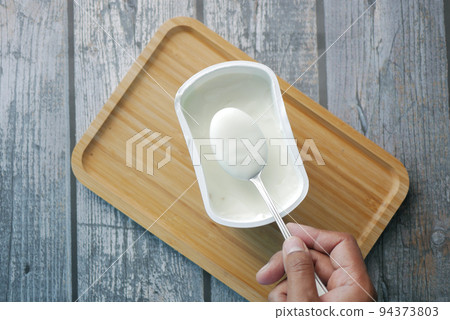 fresh yogurt in a bowl on table  94373803