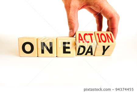 One day and action symbol. Concept words One day and One action on wooden cubes. Businessman hand. Beautiful white table white background. Business One day and action concept. Copy space. One day and action symbol. Concept words One day and One action on wooden cubes. Businessman hand. Beautiful white table white background. Business One day and action concept. Copy space. 94374455