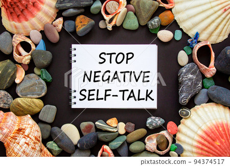 Stop negative self-talk symbol. Concept words Stop negative self-talk on a beautiful black background. Sea stones and seashells. Psychological and stop negative self-talk concept. Copy space. Stop negative self-talk symbol. Concept words Stop negative self-talk on a beautiful black background. Sea stones and seashells. Psychological and stop negative self-talk concept. Copy space. 94374517