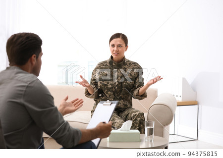 Psychotherapist working with female military officer in office 94375815