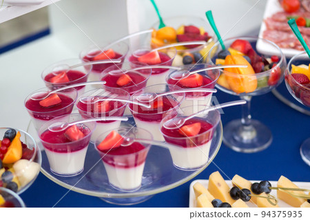 Fruit desserts on the table for a festive event or dinner Fruit desserts on the table for a festive event or dinner 94375935