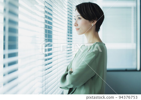 A woman by the window A woman by the window 94376753