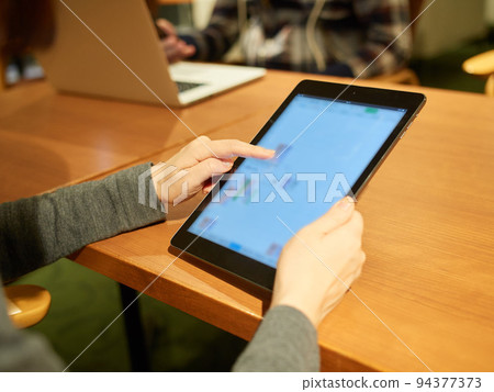 Woman having a meeting on a tablet Woman having a meeting on a tablet 94377373