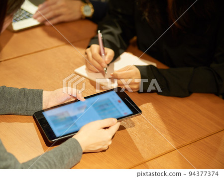 Woman having a meeting on a tablet Woman having a meeting on a tablet 94377374