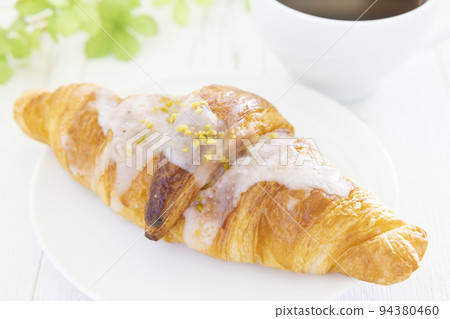 Delicious lemon croissants and hot coffee Delicious lemon croissants and hot coffee 94380460