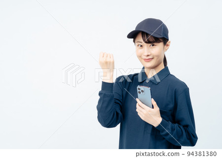 Delivery woman with smartphone (white back, guts pose) Delivery woman with smartphone (white back, guts pose) 94381380