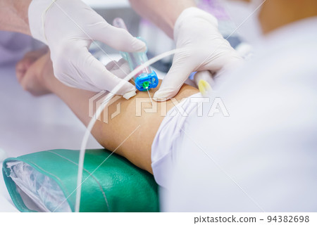 Nurse collecting a blood from patient in hospital 94382698