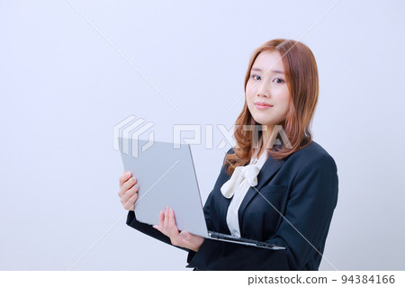 Young woman holding an open PC and looking at camera, female, pc, looking at camera, ol, clerk, laptop Young woman holding an open PC and looking at camera, female, pc, looking at camera, ol, clerk, laptop 94384166