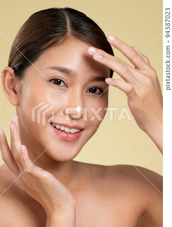 Closeup ardent girl with soft makeup applying moisturizing cream on her nose. Closeup ardent girl with soft makeup applying moisturizing cream on her nose. 94387023