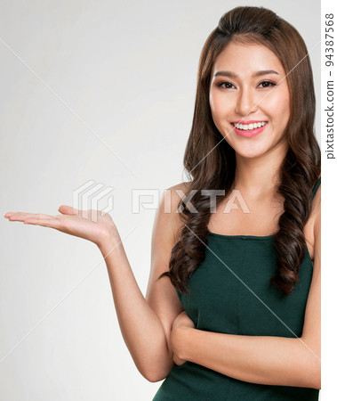 Closeup ardent woman looking at camera, holding empty space for advertising. 94387568