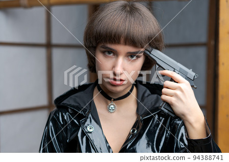 Portrait beautiful young caucasian woman in black patent suit with one hand Portrait beautiful young caucasian woman in black patent suit with one hand 94388741