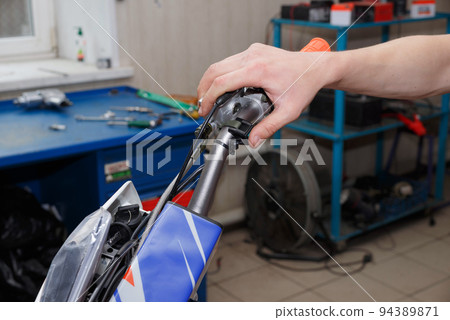 Hand pressing the Off-Run button on motorcycle Hand pressing the Off-Run button on motorcycle 94389871