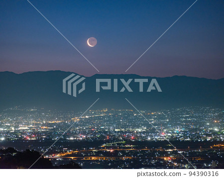 Dawn landscape with rising crescent moon 94390316