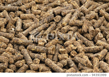 Animal feed. Sunflower granulated feed  on white background, close-up. 94391999