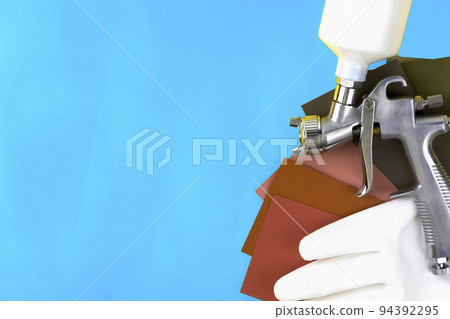 paint spray gun at work at the workplace in the workshop. paint spray gun at work at the workplace in the workshop. 94392295