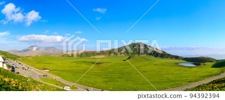 Aso crater eruption and Eboshidake in the background, Kusasenrigahama where Rhododendron kirishima flowers bloom Panoramic shot of "Aso Kusasenrigahama" 94392394