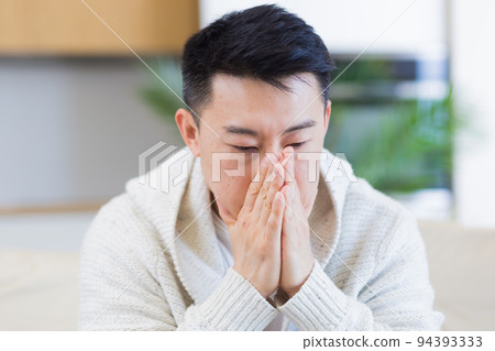 young asian man sitting on sofa at home pensive, worried about problems and depression. male has an experience relationships at work or family, problems with loan repayment debt Seriously conceived 94393333