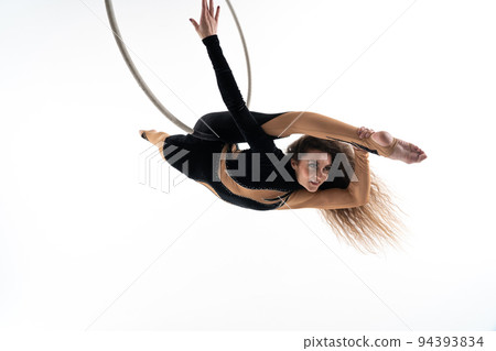Slim and flexible woman, circus artist In aerial hoop isolated On White Background. Concept of desire, will and potential Slim and flexible woman, circus artist In aerial hoop isolated On White Background. Concept of desire, will and potential 94393834