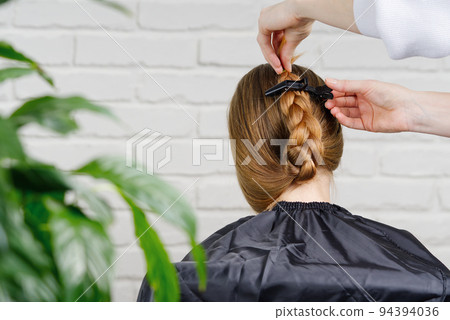 Beautiful girl with long hair. creating a hairstyle for unrecognizable girl. Hair styling process. Beautiful girl with long hair. creating a hairstyle for unrecognizable girl. Hair styling process. 94394036