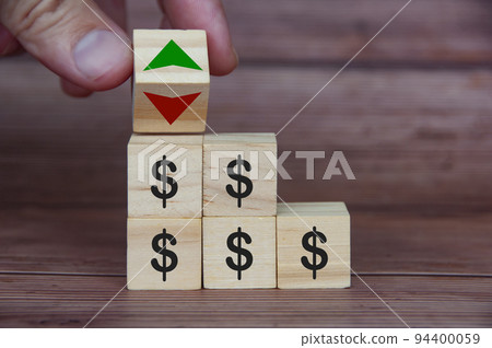 Currency fluctuation with dollar sign on wooden blocks. Currency fluctuation and wealth concept 94400059