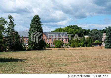 Heverlee, Flemish Brabant, Belgium - Yellow meadows and facade of the Hunt abbey Heverlee, Flemish Brabant, Belgium - Yellow meadows and facade of the Hunt abbey 94401444