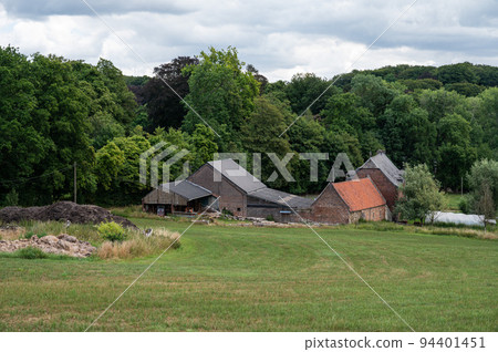 Nethen, Wallon region, Belgium , Farm houses and agriculture fields with woods in the background Nethen, Wallon region, Belgium , Farm houses and agriculture fields with woods in the background 94401451