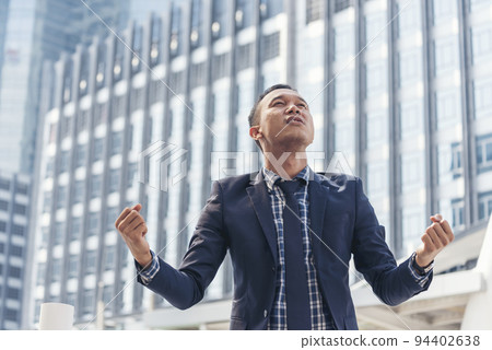Victory man power holding fist winner positive energy. Back side Man empowerment city life background. Leadership businessman person positive motivation freedom life. Winner victory people concept 94402638