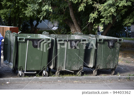 Garbage cans in the urban area and a landfill. Plastic garbage containers in the village. Garbage cans in the urban area and a landfill. Plastic garbage containers in the village. 94403362