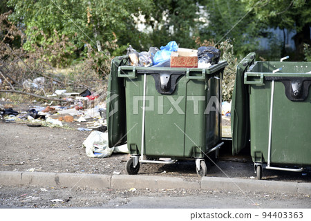 Garbage cans in the urban area and a landfill. Plastic garbage containers in the village. Garbage cans in the urban area and a landfill. Plastic garbage containers in the village. 94403363
