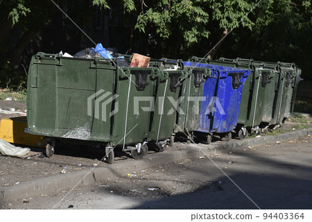Garbage cans in the urban area and a landfill. Plastic garbage containers in the village. 94403364