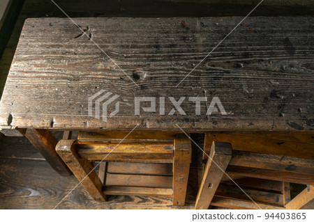 A wooden desk and chair with traces of student carvings A wooden desk and chair with traces of student carvings 94403865