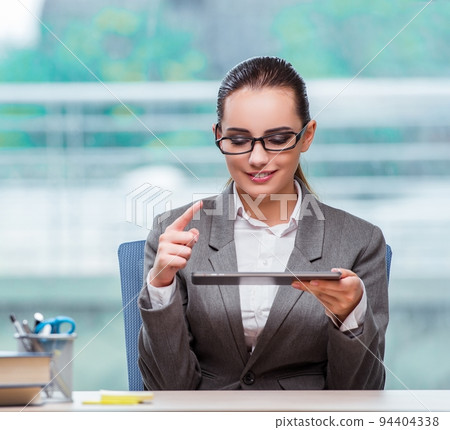 Businesswoman working with tablet computer in business concept 94404338
