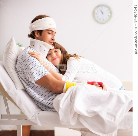 Loving wife looking after injured husband Loving wife looking after injured husband 94404543