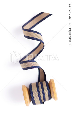 Spool with ribbon isolated on white background, top view. Sewing ribbon roll 94405036