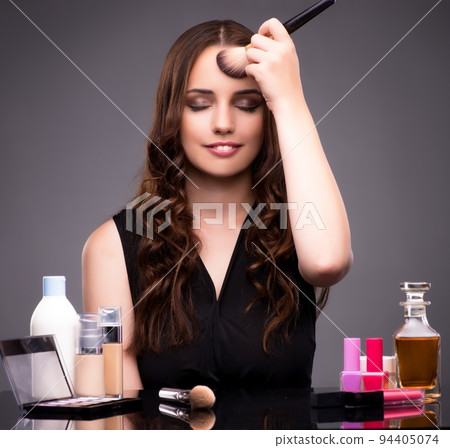 Young beautiful woman during make-up session Young beautiful woman during make-up session 94405074