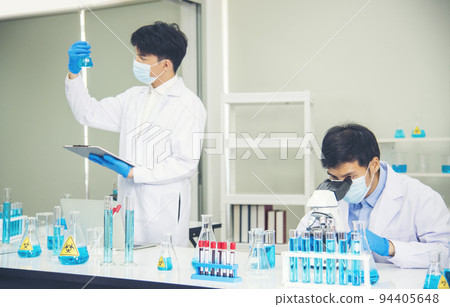 Two asian scientist team reserch chemistry science tube experiment biotech antibody sample in laboratory Cultivate Vaccine against covid-19 virus. Scientist consult, analyze in Chemistry Laboratory Two asian scientist team reserch chemistry science tube experiment biotech antibody sample in laboratory Cultivate Vaccine against covid-19 virus. Scientist consult, analyze in Chemistry Laboratory 94405648