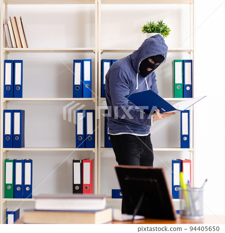 Male thief in balaclava in the office 94405650
