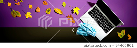 Laptop computer with masks in autumn Laptop computer with masks in autumn 94405901