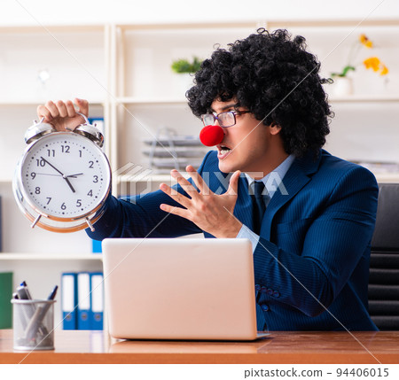 Young clown businessman working in the office Young clown businessman working in the office 94406015