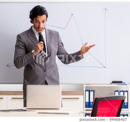 Young handsome businessman in front of whiteboard Young handsome businessman in front of whiteboard 94406407