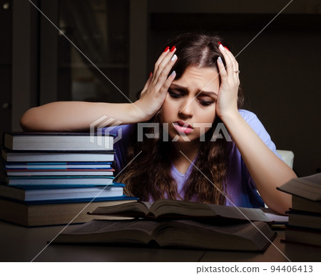 Young female student preparing for exams late at home Young female student preparing for exams late at home 94406413