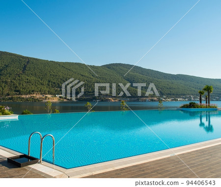 Nice swimming pool outdoors on bright summer day Nice swimming pool outdoors on bright summer day 94406543