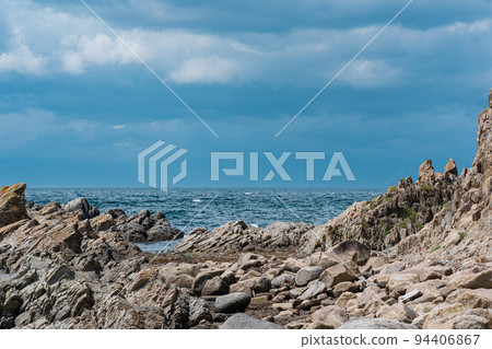 sharp jagged basalt rocks on the sea coast sharp jagged basalt rocks on the sea coast 94406867