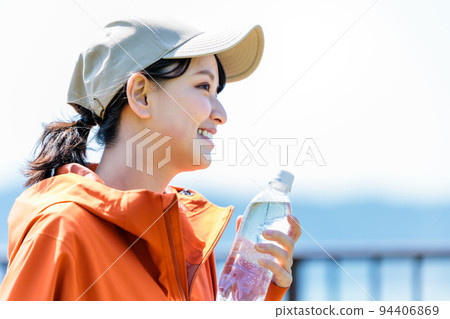 Young woman with plastic bottle for hydration 94406869