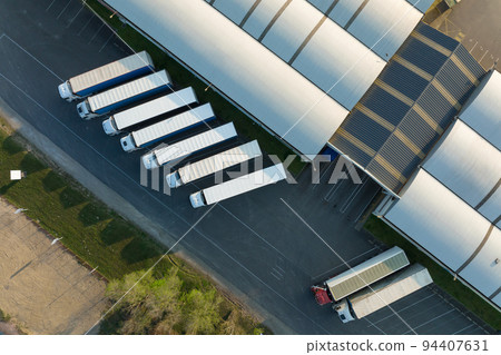 Aerial view of goods warehouses and logistics center in industrial city zone from above 94407631