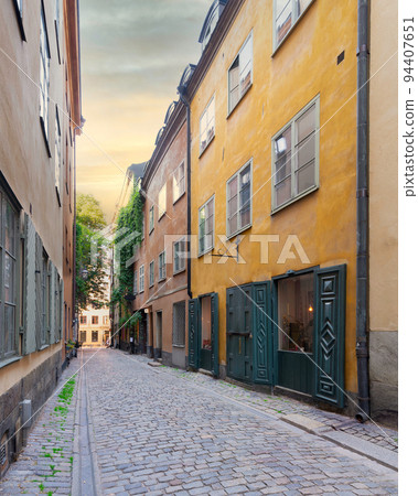 Narrow alley in Gamla stan, the old town of Stockholm, Sweden with old style colorful houses and cobblestone street Narrow alley in Gamla stan, the old town of Stockholm, Sweden with old style colorful houses and cobblestone street 94407651