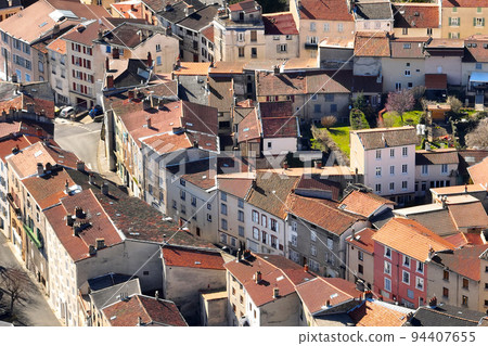 Aerial view of dense historic center of Thiers town in Puy-de-Dome department, Auvergne-Rhone-Alpes region in France. Rooftops of old buildings and narrow streets Aerial view of dense historic center of Thiers town in Puy-de-Dome department, Auvergne-Rhone-Alpes region in France. Rooftops of old buildings and narrow streets 94407655