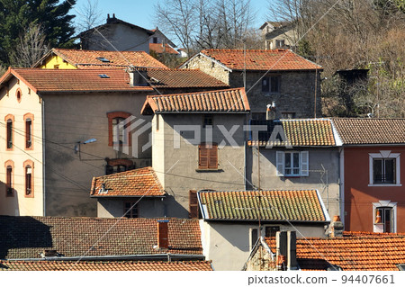 Aerial view of dense historic center of Thiers town in Puy-de-Dome department, Auvergne-Rhone-Alpes region in France. Rooftops of old buildings and narrow streets 94407661