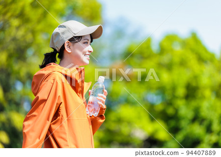 Young woman with plastic bottle for hydration Young woman with plastic bottle for hydration 94407889